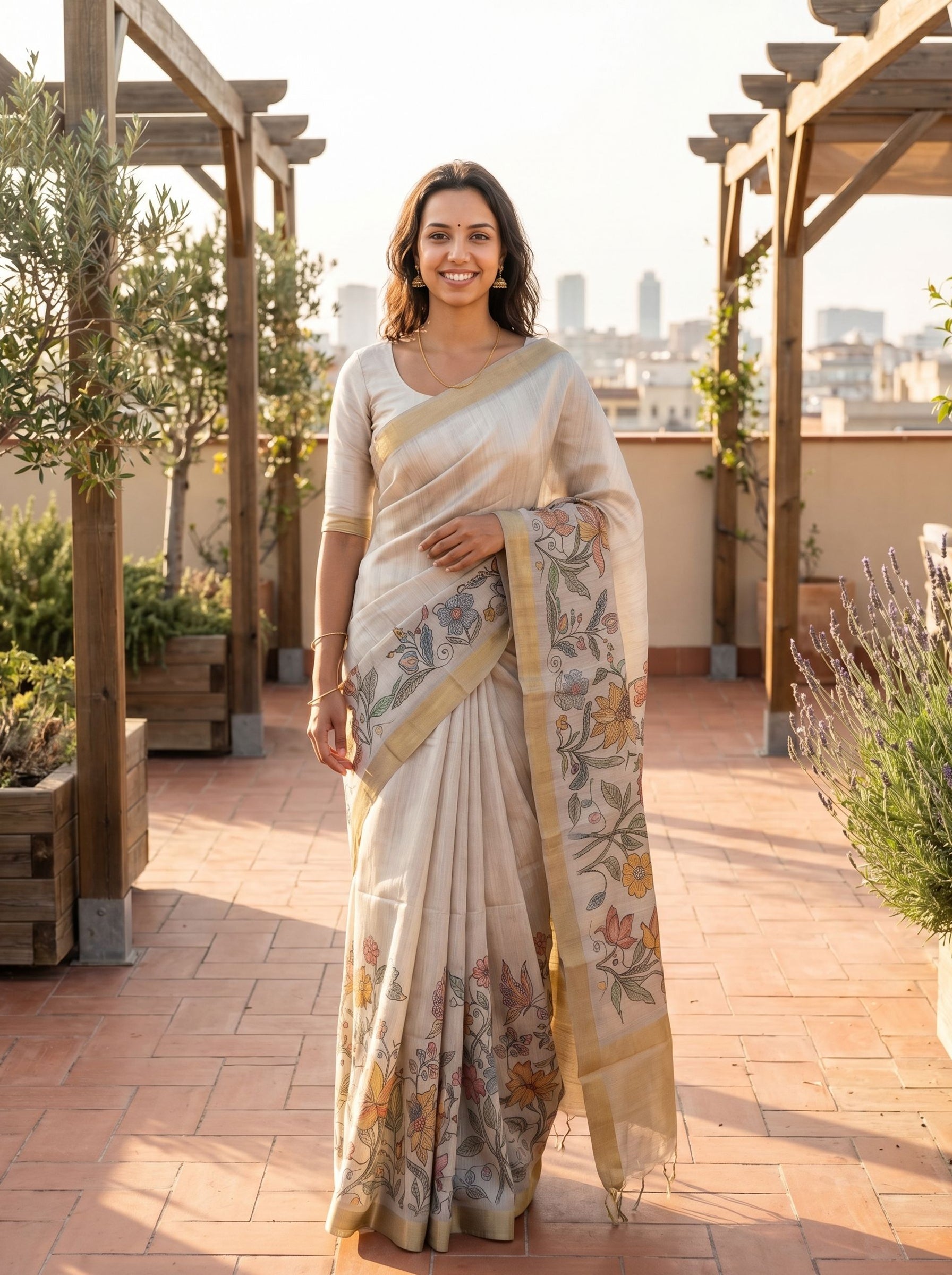 Woman in a Off White saree with floral patterns on a rooftop with plants and cityscape in the background