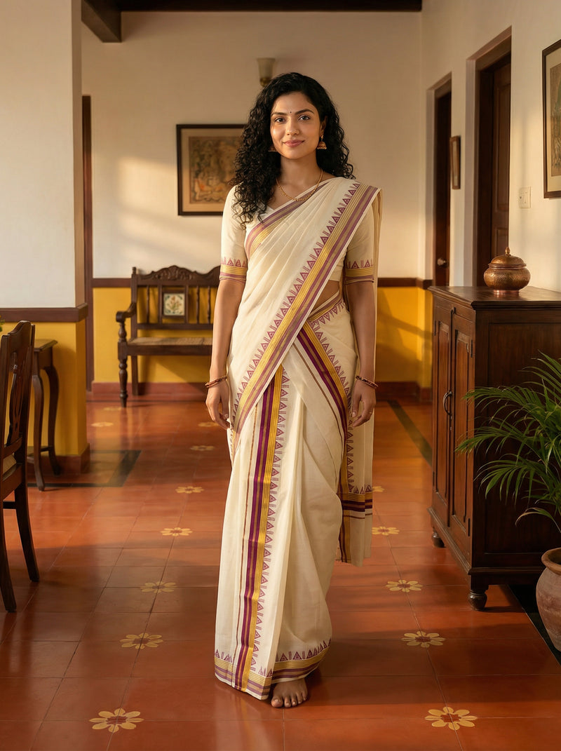 Woman in a traditional saree standing in a room with wooden furniture and decor.