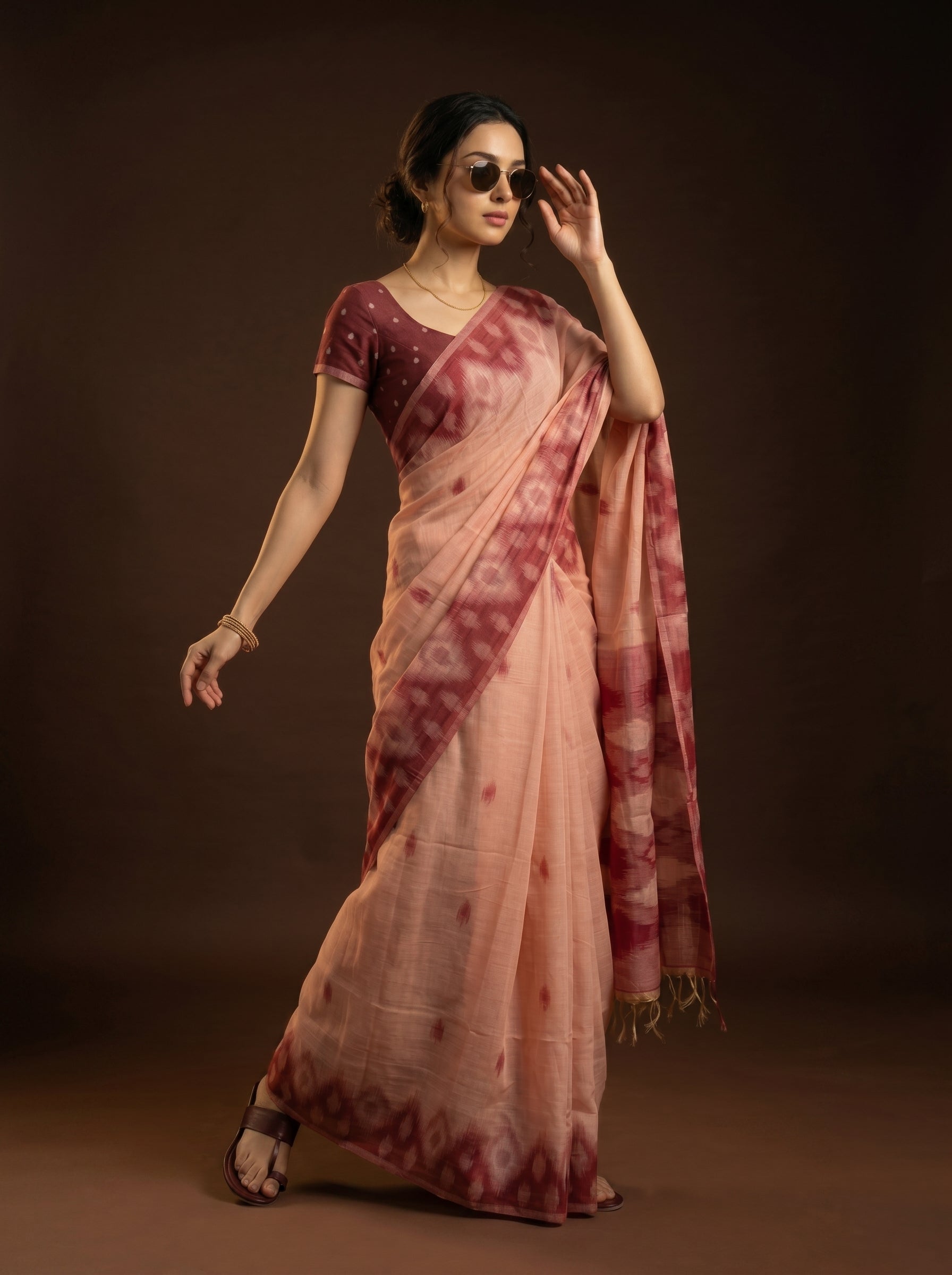 Woman wearing a traditional saree with a dark background