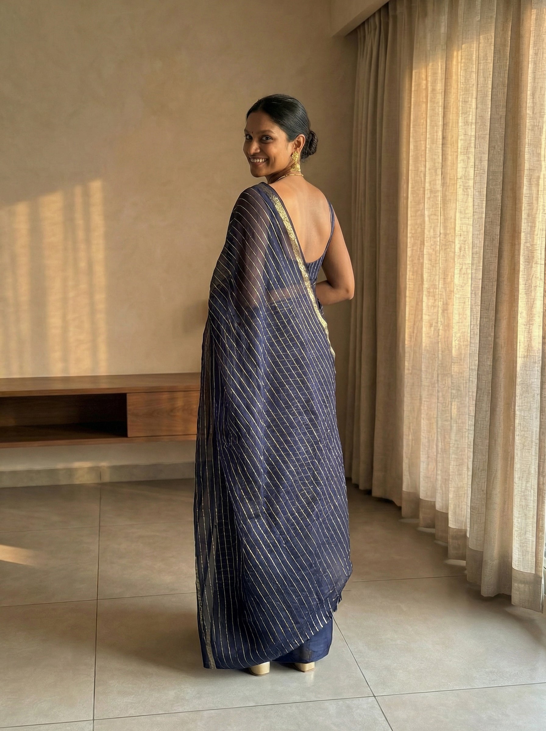 Synthetic Navy Blue Saree with Elegant Gold Stripe Pattern