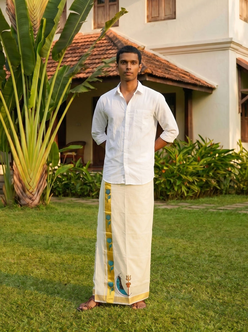 Man in traditional white shirt and dhoti standing in a garden with a house in the background
