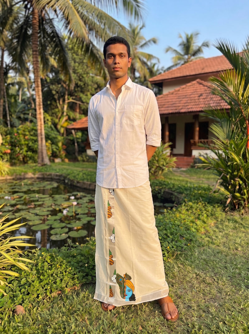 Man in traditional attire standing in a garden with palm trees and a house in the background
