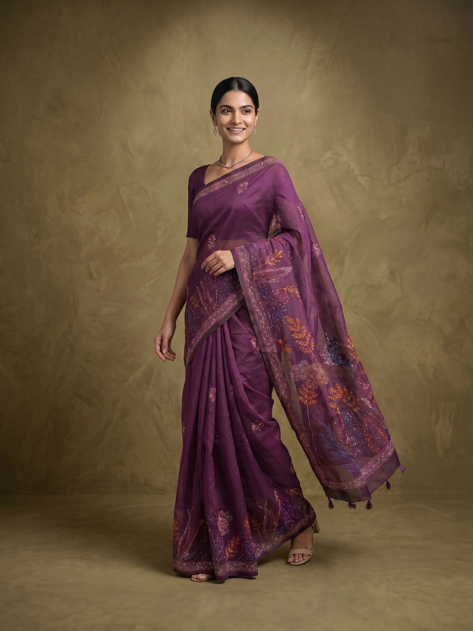 Woman wearing a purple saree with a textured background