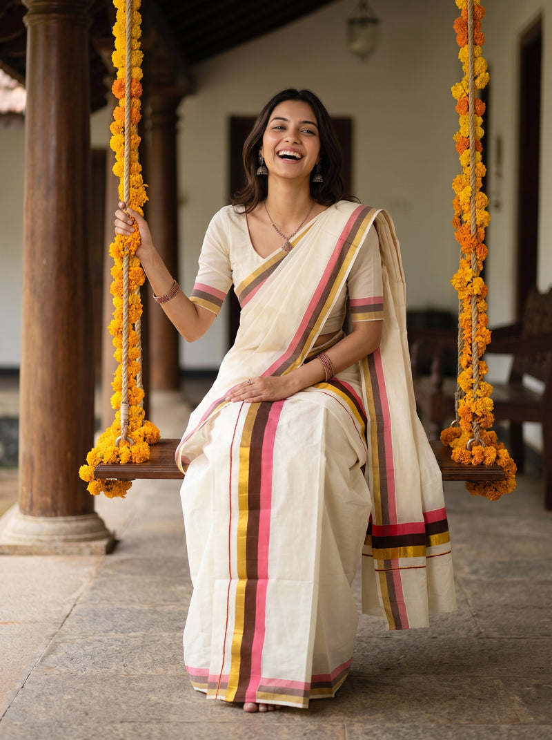 A woman wearing a cream-colored cotton saree with pink, yellow, and green stripes sits on a wooden swing decorated with marigold garlands in a traditional courtyard.